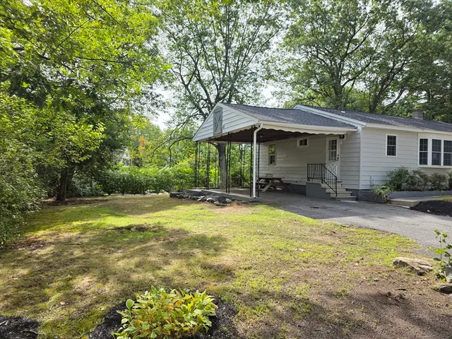 a view of a swimming pool with lawn chairs under an umbrella