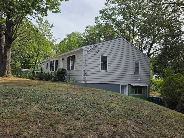 a front view of a house with a garden