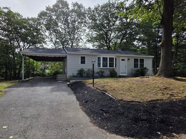 a view of a house with a yard and plants