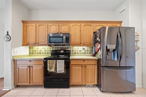 a kitchen with stainless steel appliances granite countertop a refrigerator and a stove