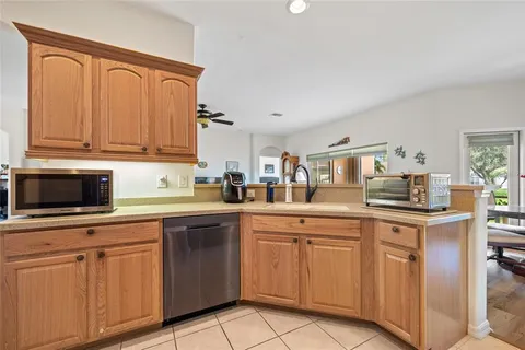 a kitchen with cabinets appliances and a sink