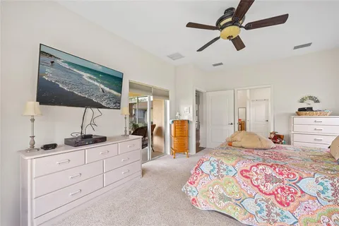 a bedroom with a bed a lamp and a window