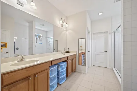 a spacious bathroom with a granite countertop sink mirror and shower