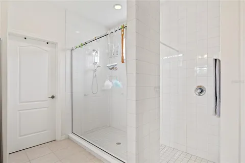 a bathroom with a shower and a glass door