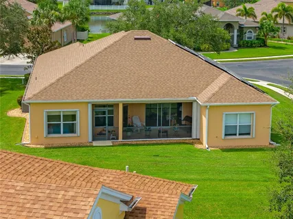 a front view of a house with a yard and potted plants