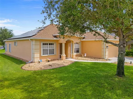 a front view of house with a garden and patio