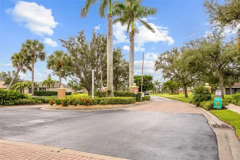 a view of a park with a cars park and palm trees