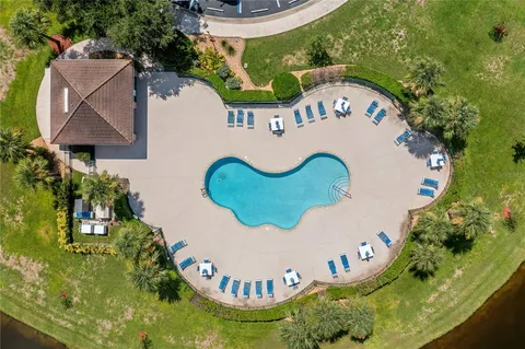 an aerial view of a house with swimming pool and porch
