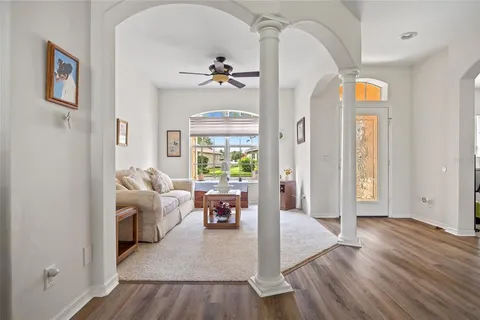 a living room with furniture and wooden floor