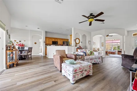 a living room with furniture and a wooden floor
