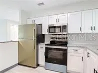 a kitchen with a refrigerator stove and microwave