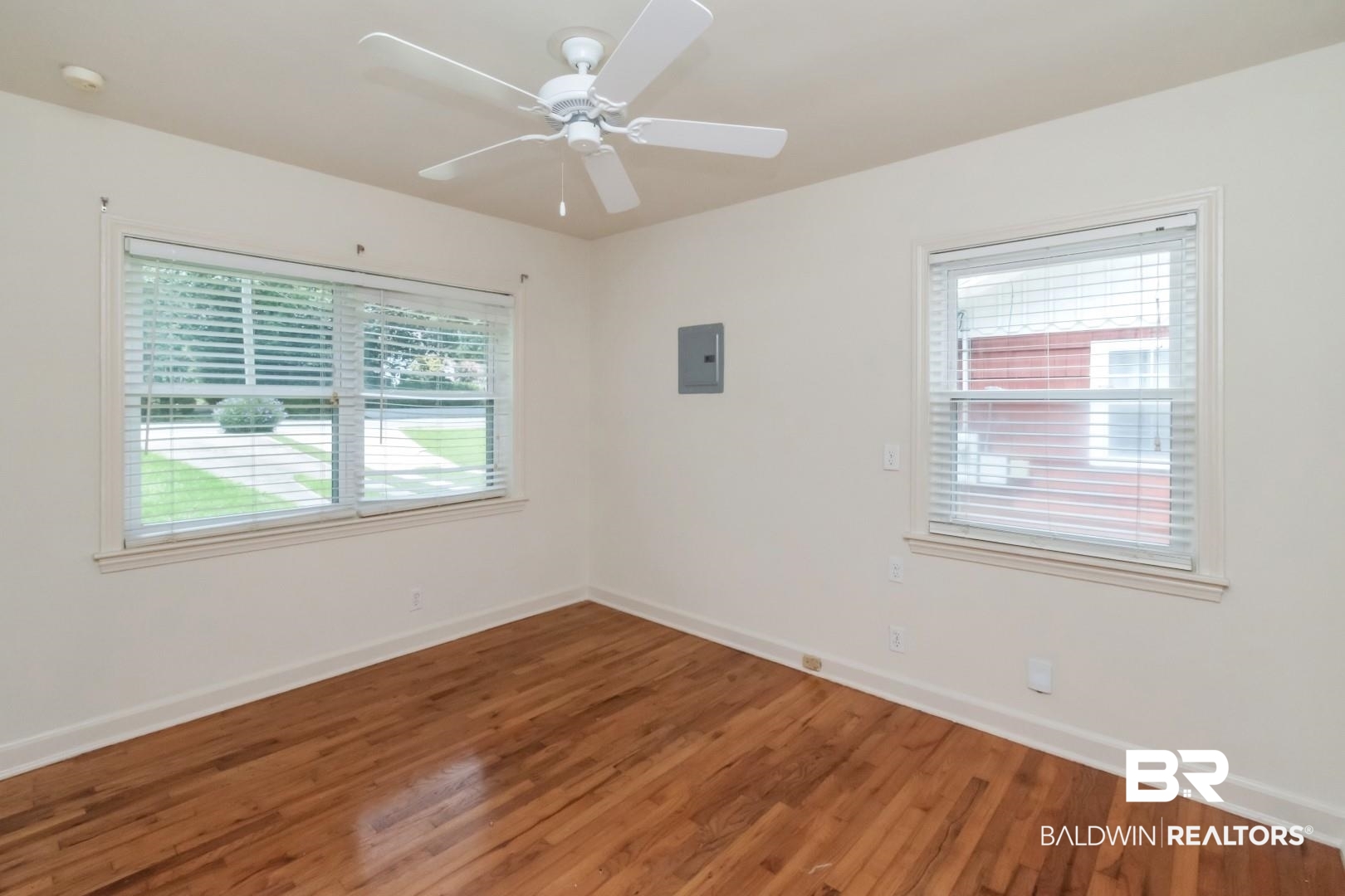 1906 Old Shell Road Mobile, AL 36607 - Photo 25 of 26 Empty room with ceiling fan, hardwood / wood-style flooring, and electric panel