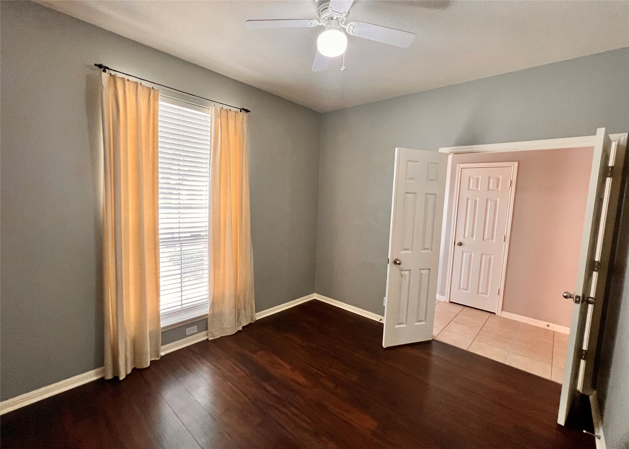 16616 Bridgefarmer Boulevard Pflugerville, TX 78660 - Photo 12 of 36 an empty room with wooden floor and windows