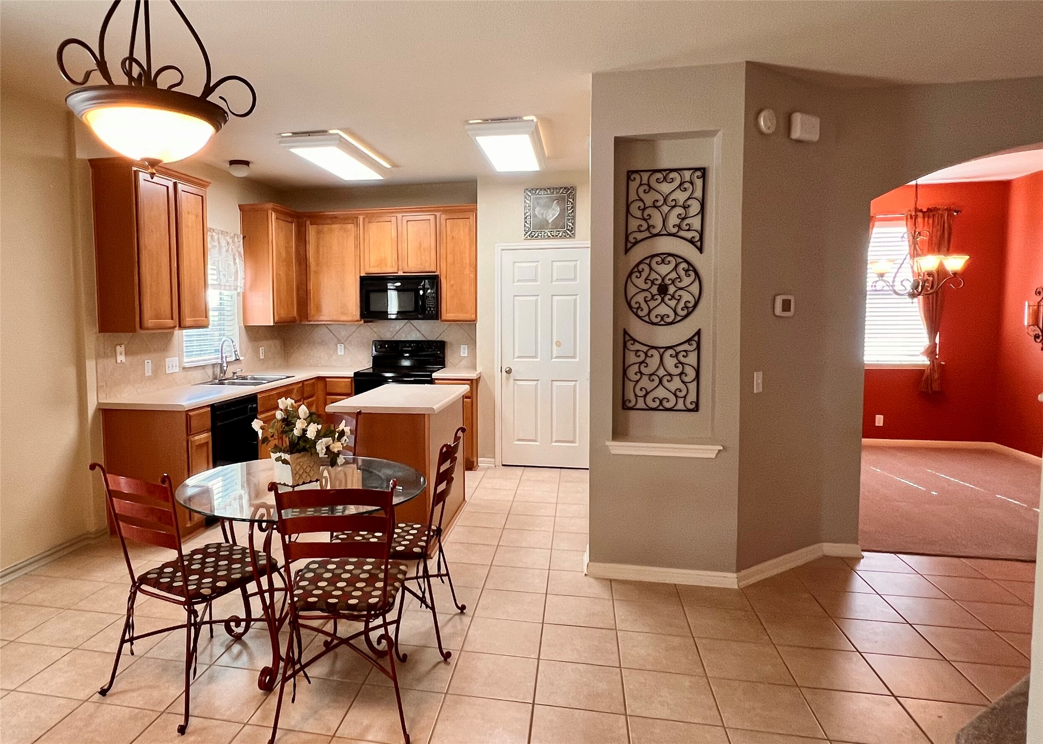 16616 Bridgefarmer Boulevard Pflugerville, TX 78660 - Photo 6 of 36 a view of a kitchen with a dining table and chairs