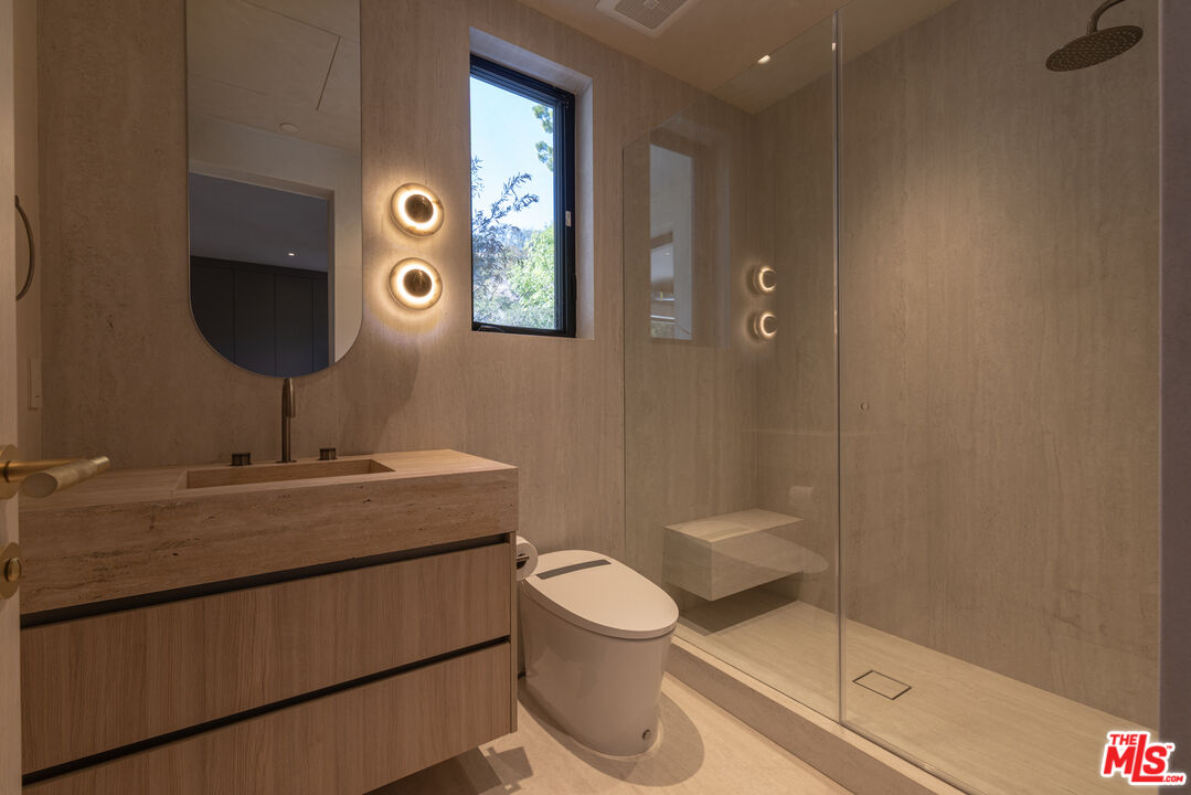 17177 Adlon Road Encino, CA 91436 - Photo 14 of 20 a bathroom with a toilet a sink and mirror