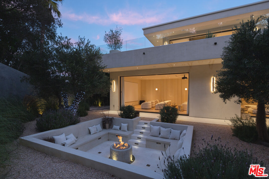 17177 Adlon Road Encino, CA 91436 - Photo 19 of 20 a front view of a house with garden and patio