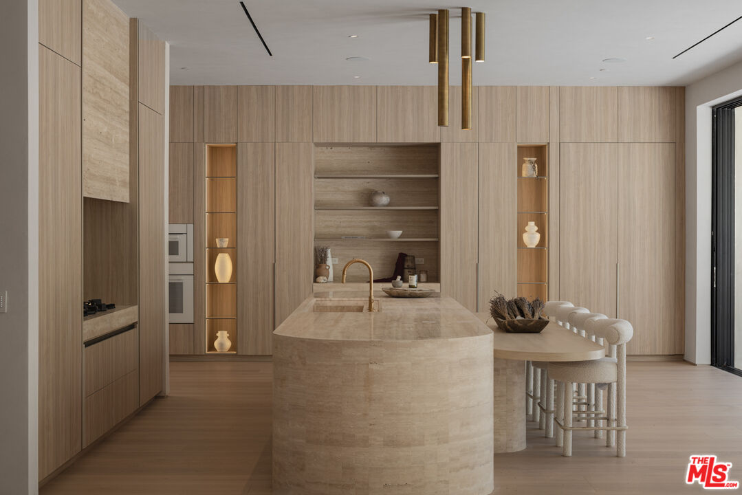 17177 Adlon Road Encino, CA 91436 - Photo 7 of 20 a kitchen with refrigerator and cabinets