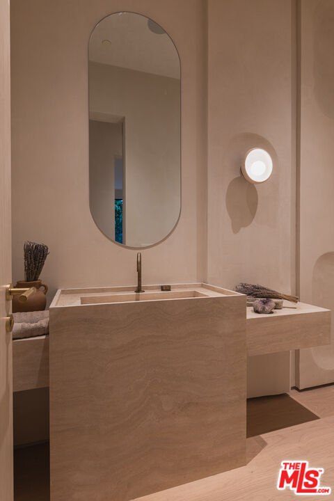 17177 Adlon Road Encino, CA 91436 - Photo 8 of 20 a bathroom with a sink and a mirror