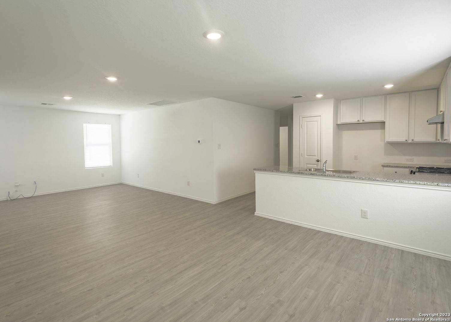 5909 San Geronimo Seguin, TX 78155 - Photo 4 of 16 an empty room with wooden floor and windows