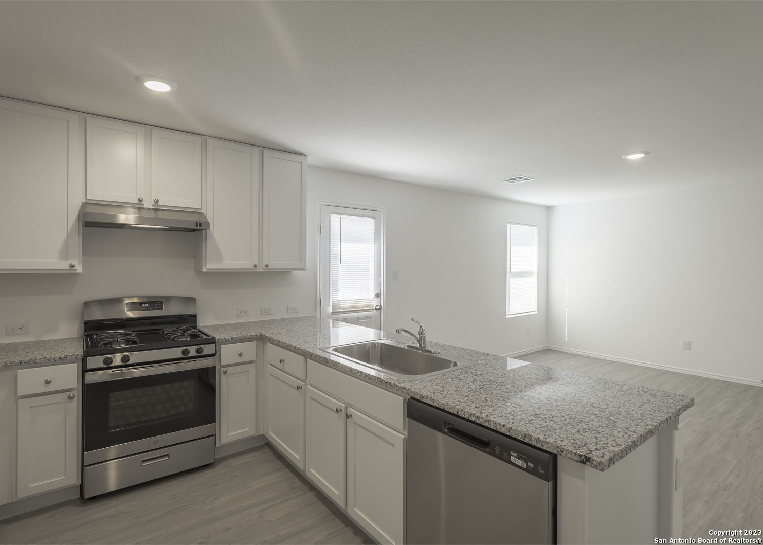 5909 San Geronimo Seguin, TX 78155 - Photo 6 of 16 a kitchen with granite countertop stainless steel appliances a sink stove and cabinets
