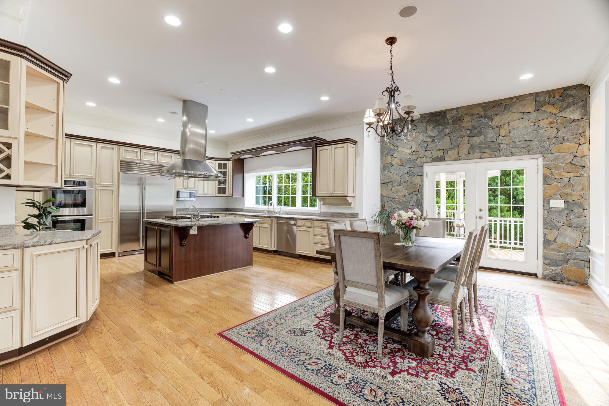 6318 Georgetown Pike McLean, VA 22101 - Photo 11 of 47 a large kitchen with kitchen island a dining table and chairs