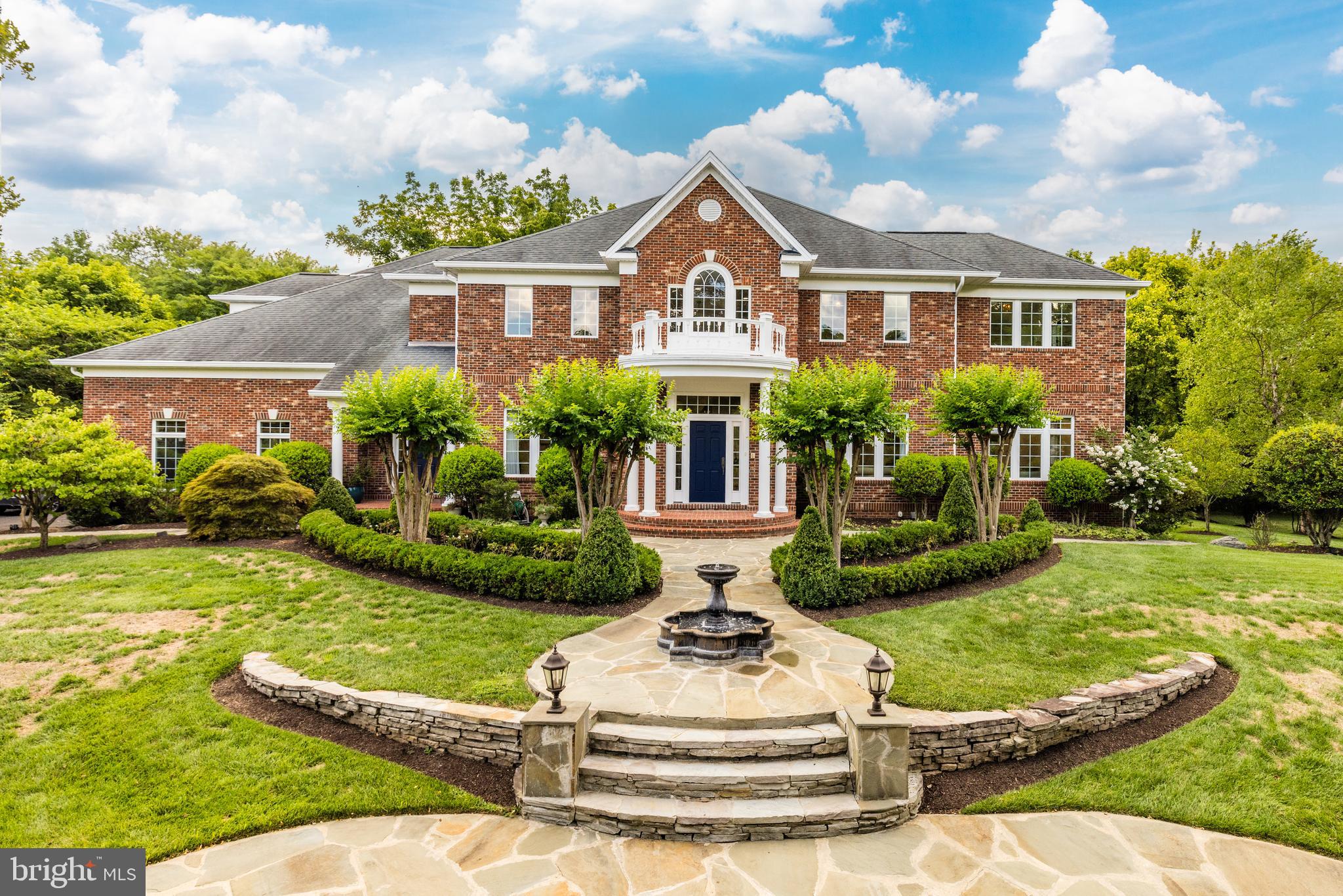 6318 Georgetown Pike McLean, VA 22101 - Photo 2 of 47 a front view of a house with a garden and trees