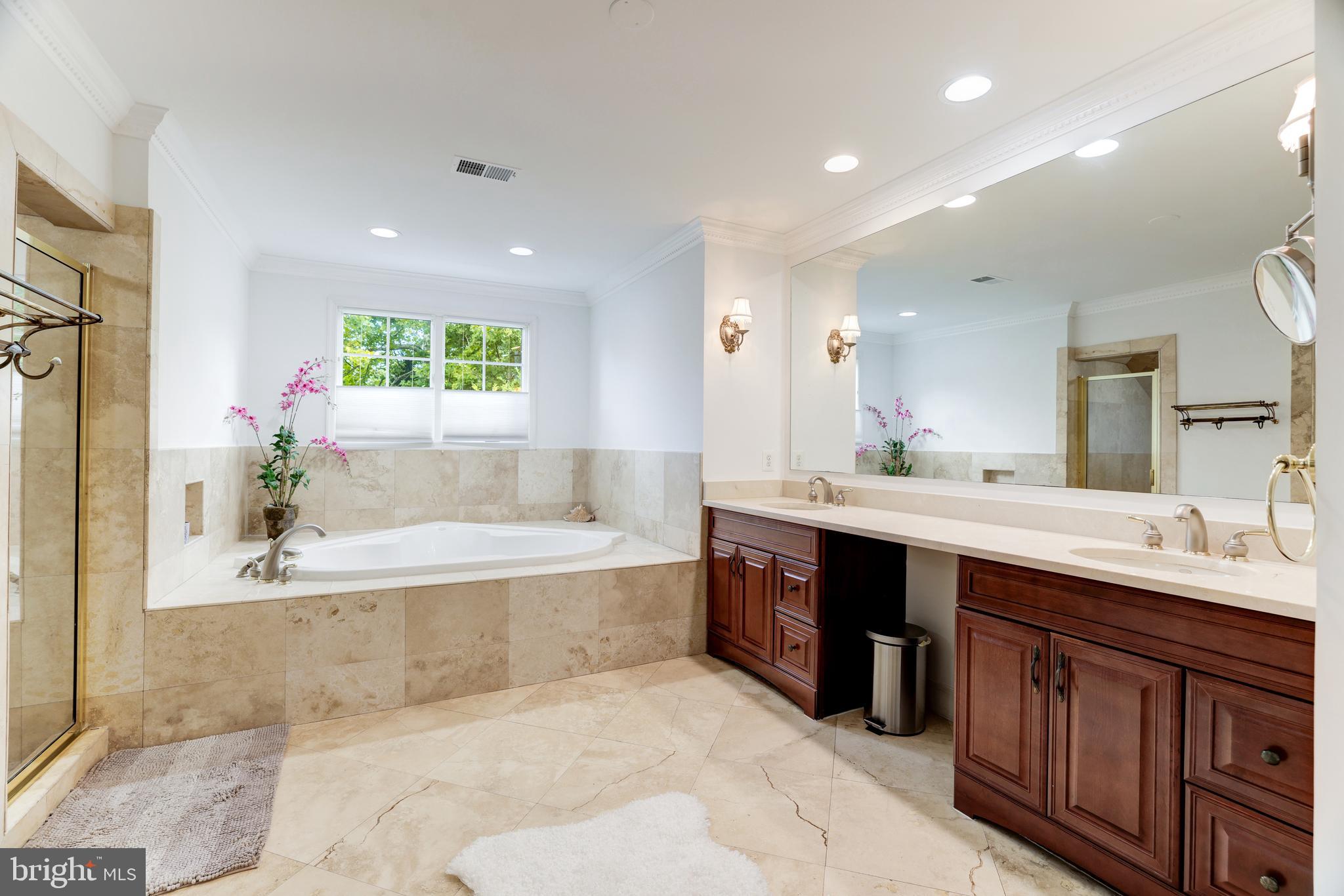 6318 Georgetown Pike McLean, VA 22101 - Photo 33 of 47 a spacious bathroom with a large tub shower and sink