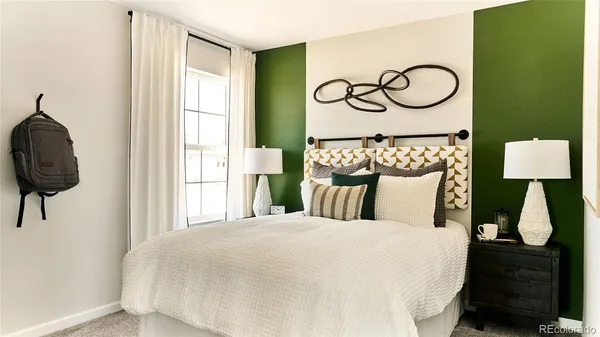 a living room with a bed and a window