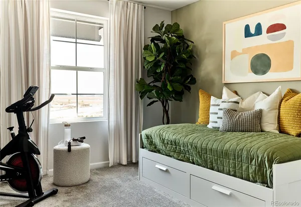 a bed sitting in a bedroom next to a window