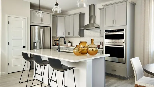 a kitchen with sink refrigerator and cabinets
