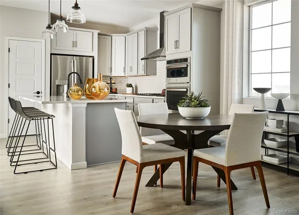 a dining room with furniture a chandelier and wooden floor