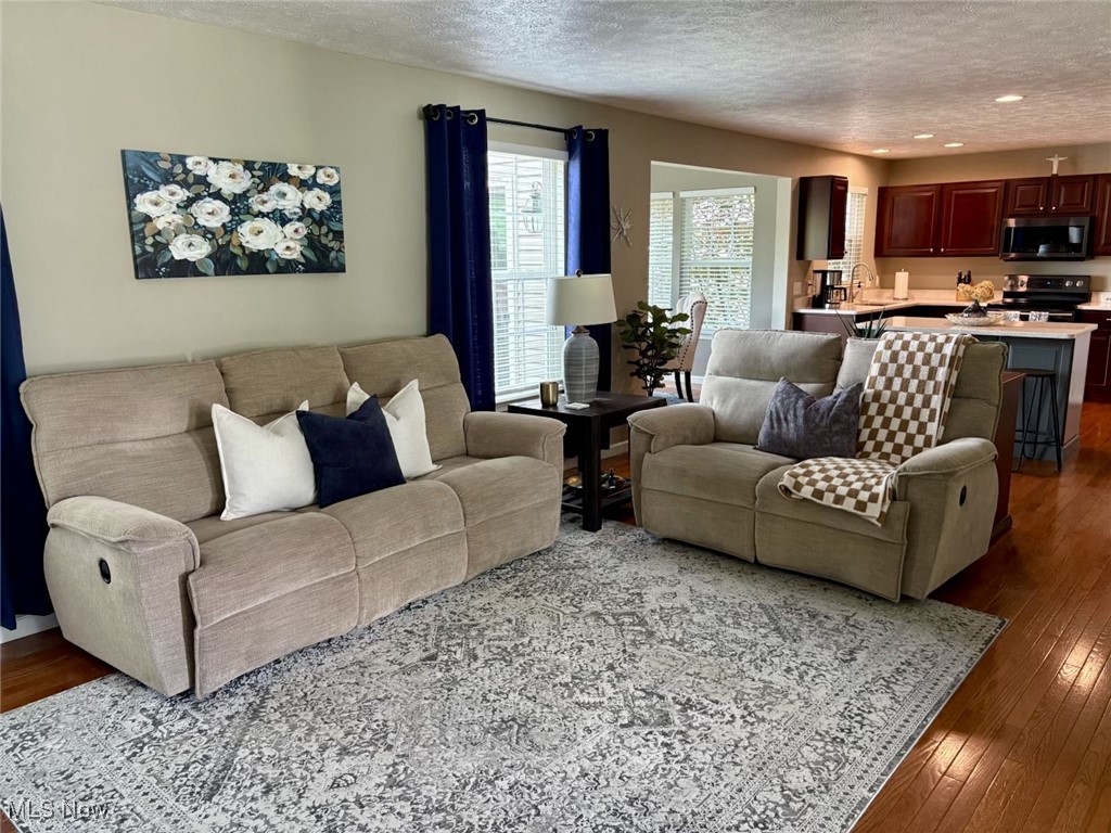 4156 Whitestone Road Kent, OH 44240 - Photo 12 of 28 Living room featuring a textured ceiling, dark wood finished floors, and recessed lighting