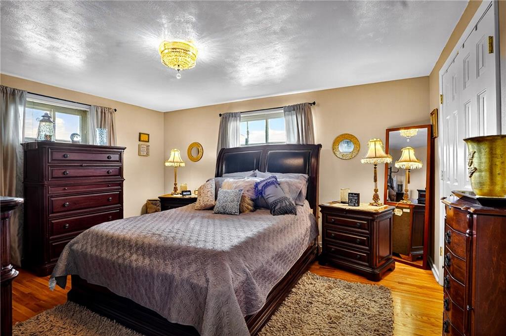 104 Thorncrest Drive McKees Rocks, PA 15136 - Photo 12 of 34 a bedroom with a bed and dresser with mirror