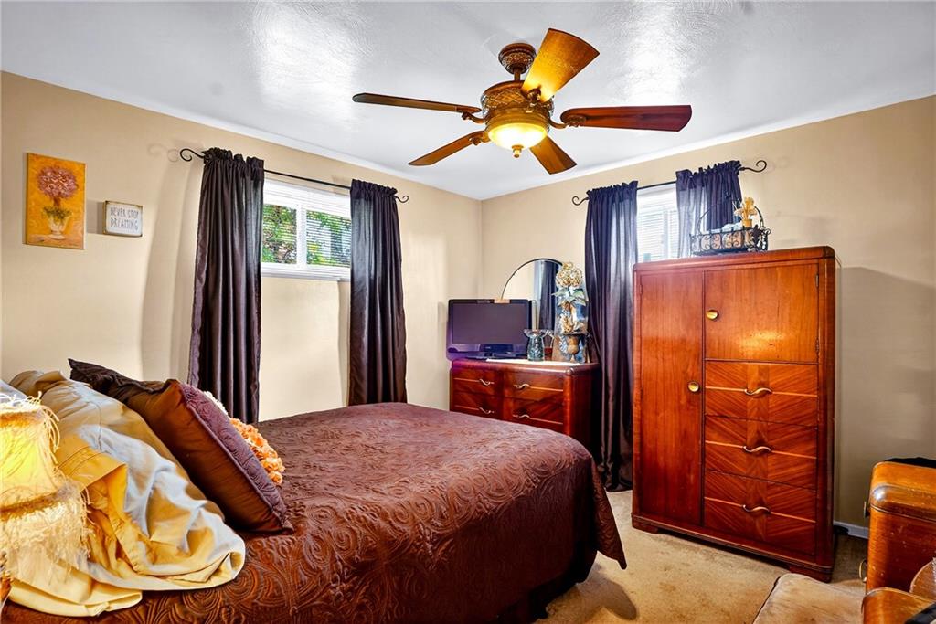 104 Thorncrest Drive McKees Rocks, PA 15136 - Photo 16 of 34 a bedroom with a bed and a chandelier