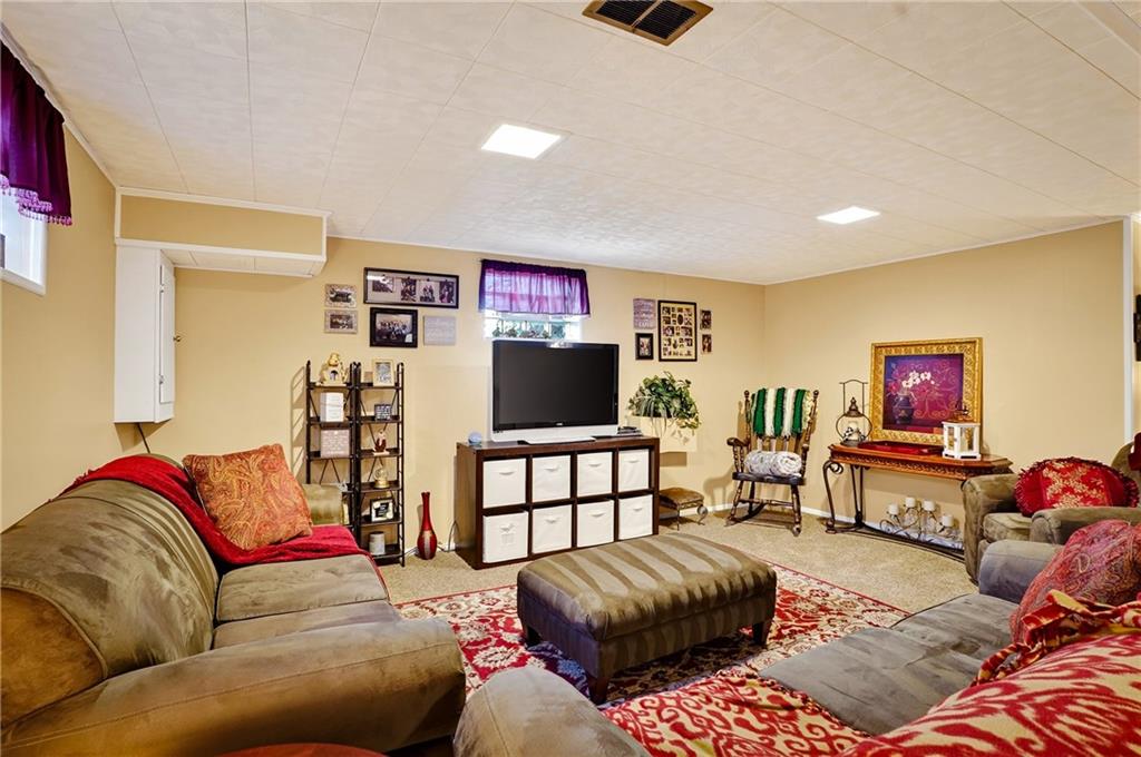 104 Thorncrest Drive McKees Rocks, PA 15136 - Photo 21 of 34 a living room with furniture and a flat screen tv