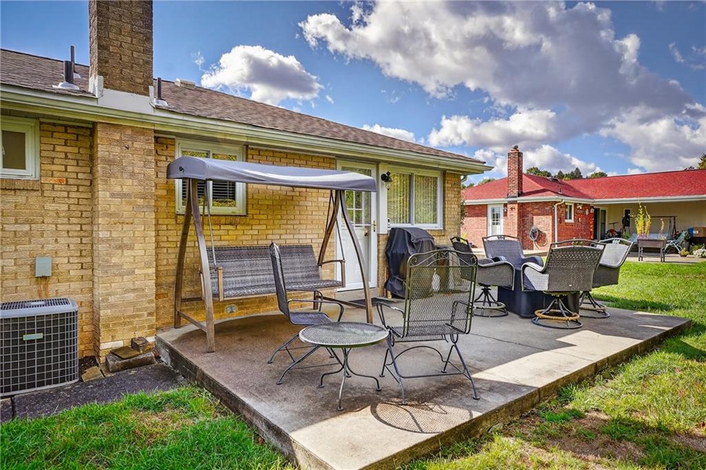 104 Thorncrest Drive McKees Rocks, PA 15136 - Photo 30 of 34 a view of a patio with table and chairs with wooden fence