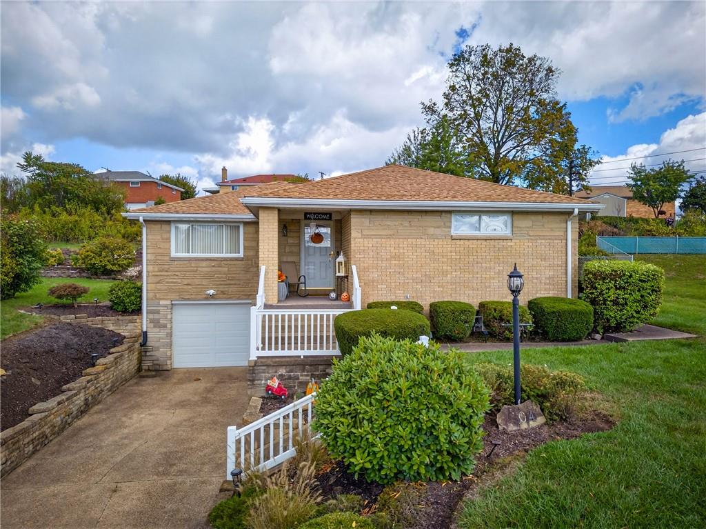 104 Thorncrest Drive McKees Rocks, PA 15136 - Photo 32 of 34 a front view of a house with a yard and green space