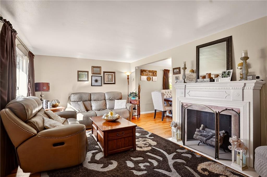 104 Thorncrest Drive McKees Rocks, PA 15136 - Photo 4 of 34 a living room with furniture a fireplace and a large mirror next to a window