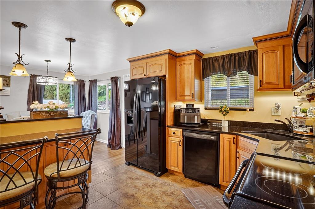 104 Thorncrest Drive McKees Rocks, PA 15136 - Photo 10 of 34 a kitchen with stainless steel appliances granite countertop a refrigerator and a stove top oven
