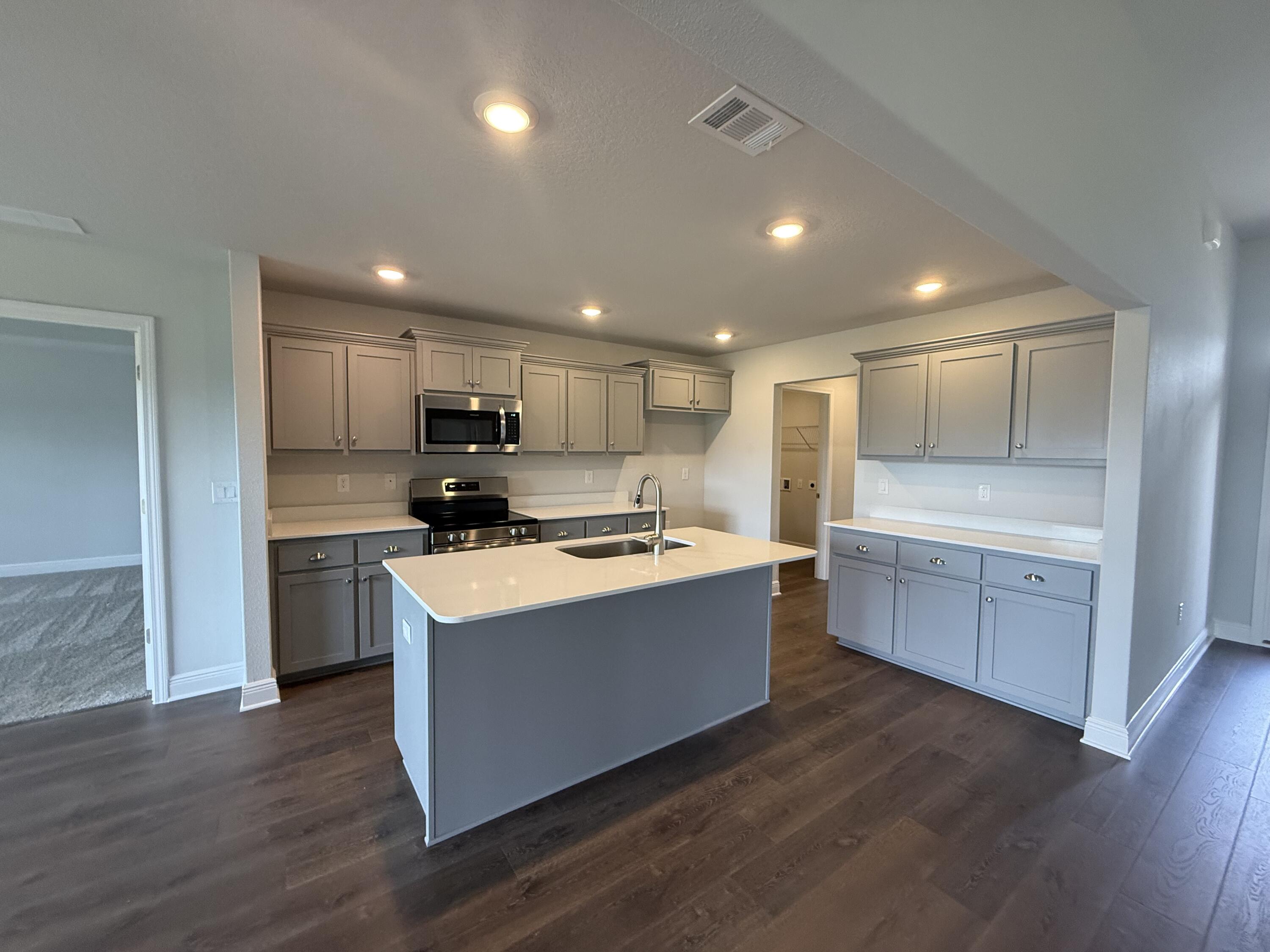 6004 Crocket Cove Crestview, FL 32539 - Photo 17 of 24 a large kitchen with stainless steel appliances granite countertop a white stove top oven and cabinets
