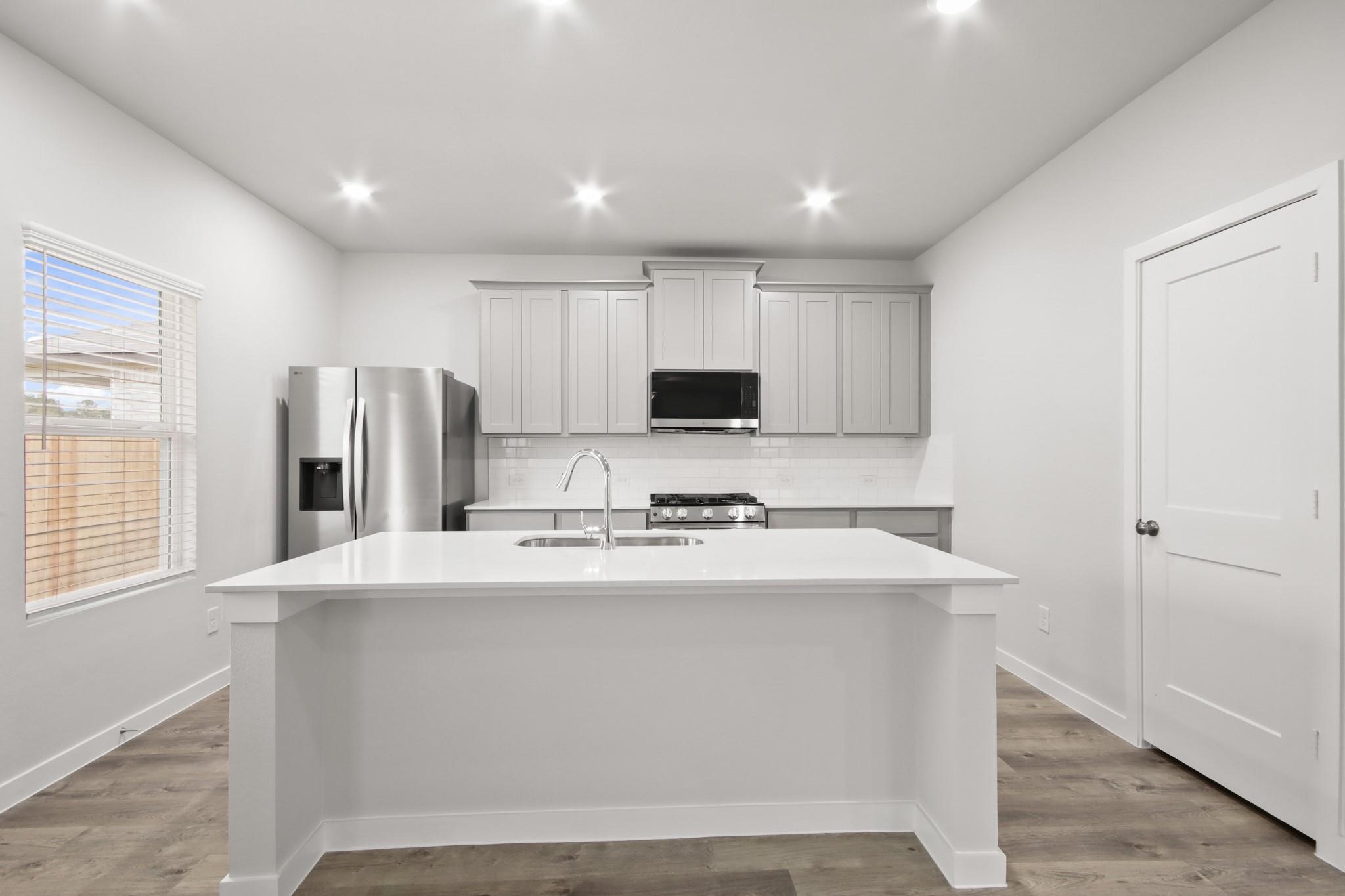 227 Brazen Forest Trail Magnolia, TX 77354 - Photo 5 of 22 a kitchen with stainless steel appliances a refrigerator sink and microwave