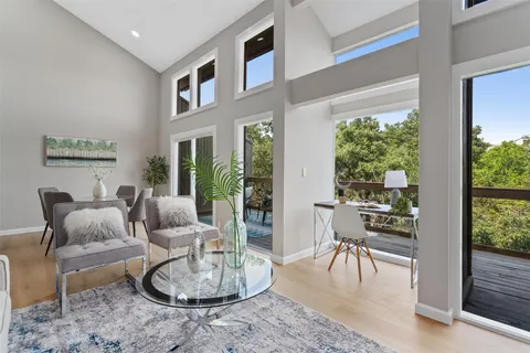 a living room with furniture a rug and a chandelier