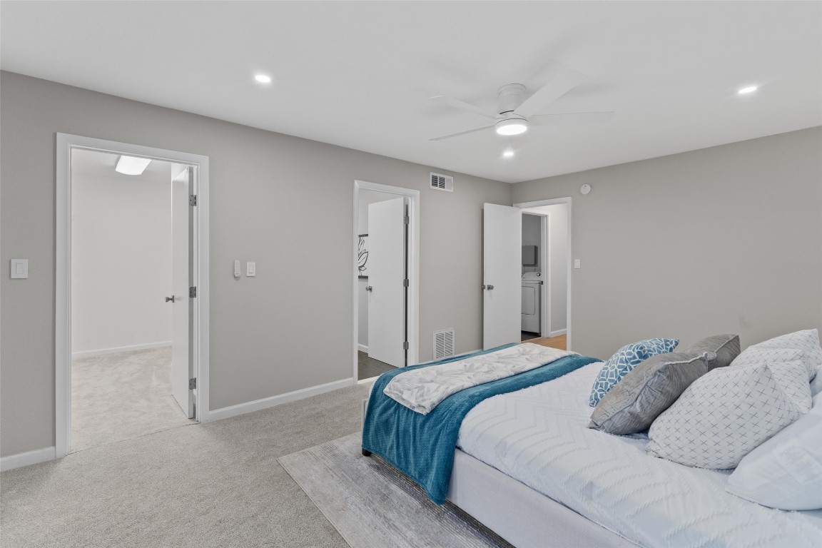 103 Comanche Drive Point Venture, TX 78645 - Photo 22 of 38 a bedroom with a large bed and a chandelier