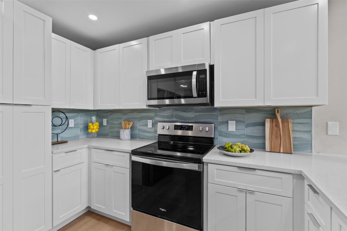 103 Comanche Drive Point Venture, TX 78645 - Photo 6 of 38 a kitchen with stainless steel appliances granite countertop white cabinets a stove a sink and dishwasher