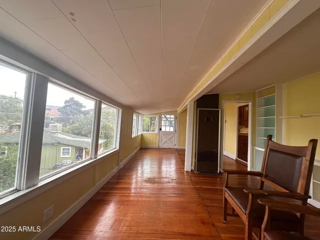 a view of a room with furniture and windows