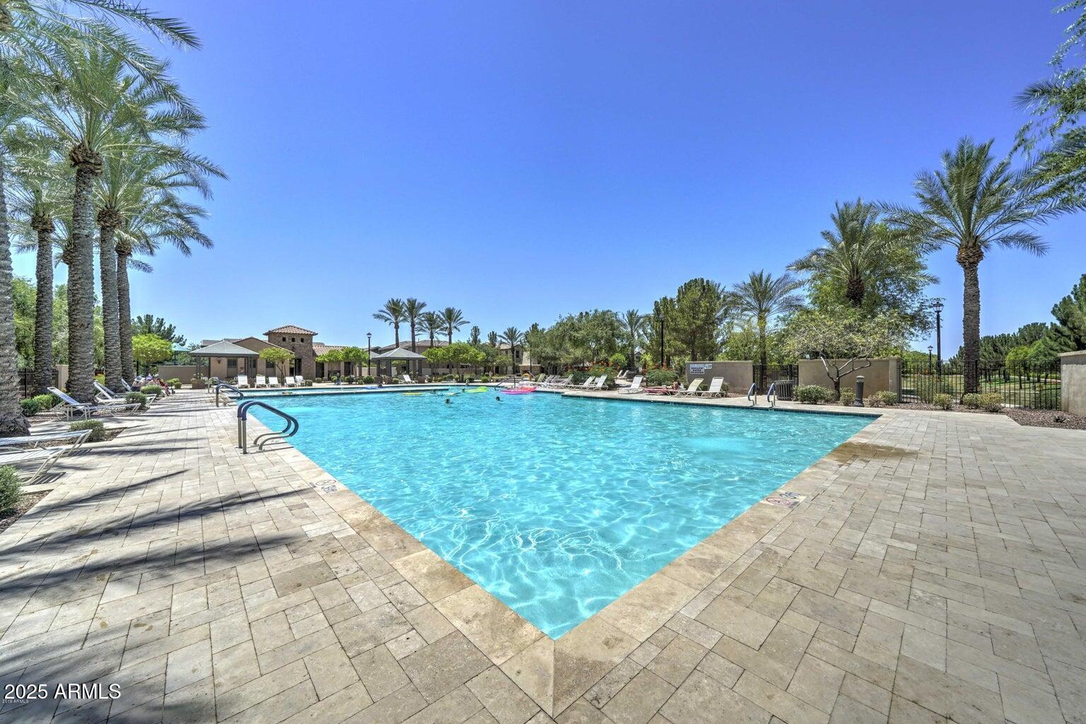 878 South Huish Drive, Unit LOT 105 Gilbert, AZ 85296 - Photo 35 of 51 a view of a lake with a yard and palm trees