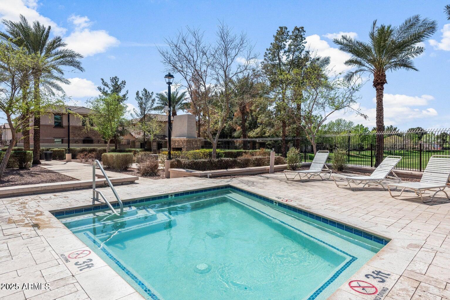 878 South Huish Drive, Unit LOT 105 Gilbert, AZ 85296 - Photo 36 of 51 a view of a swimming pool with chairs