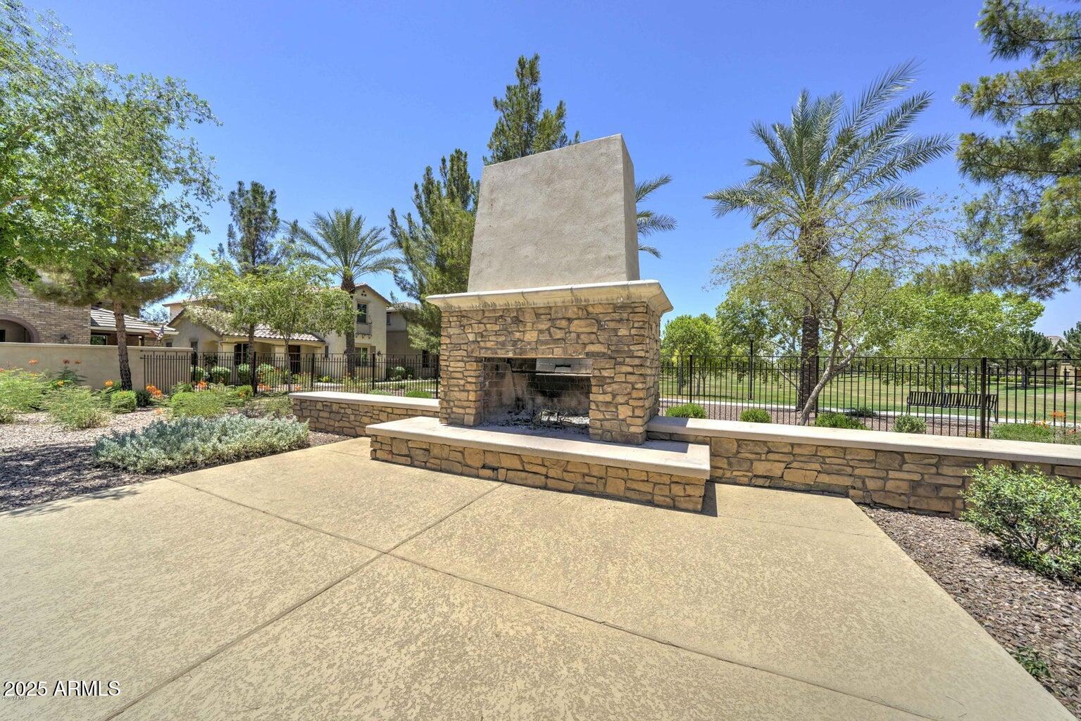 878 South Huish Drive, Unit LOT 105 Gilbert, AZ 85296 - Photo 45 of 51 a view of a house with a yard and a fountain