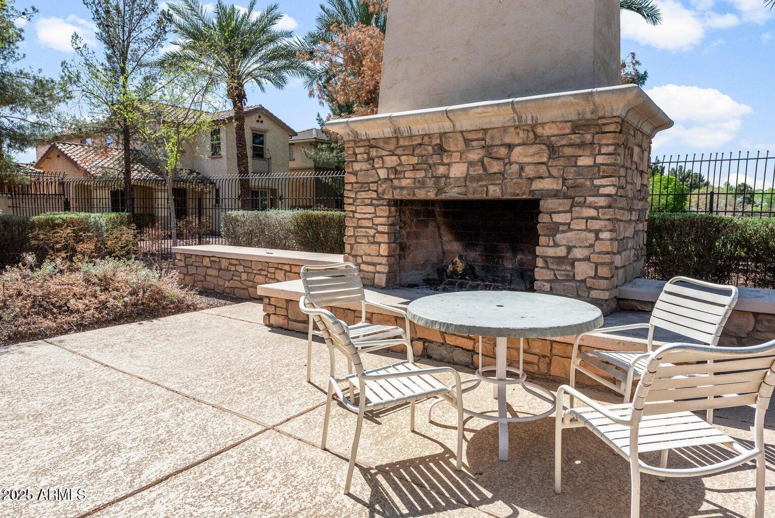878 South Huish Drive, Unit LOT 105 Gilbert, AZ 85296 - Photo 46 of 51 a view of a patio with table and chairs and potted plants