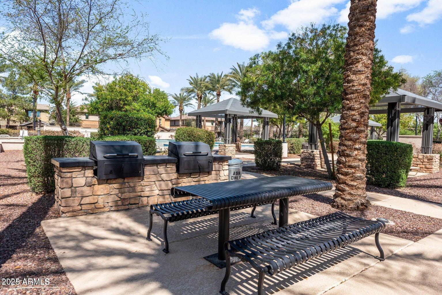 878 South Huish Drive, Unit LOT 105 Gilbert, AZ 85296 - Photo 47 of 51 a view of a patio with couches table and chairs and potted plants